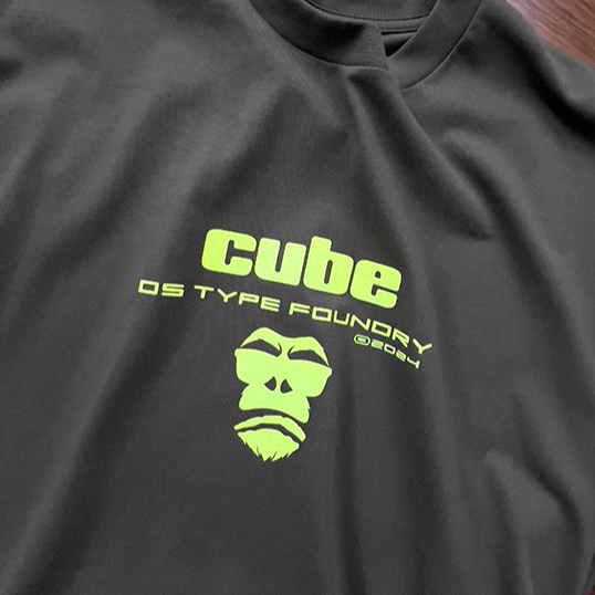 Cube in Neon Yellow on Army Green tee. 100% cotton. Typeface: Cube