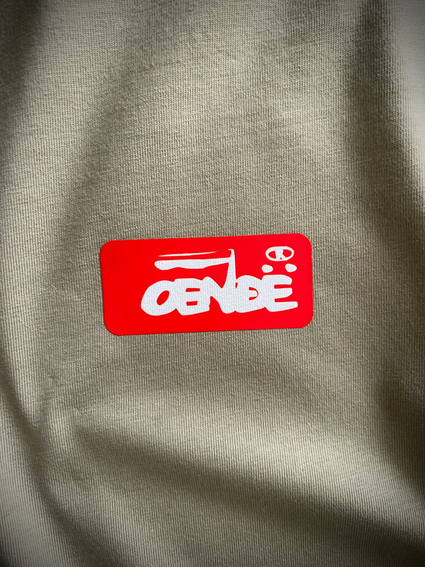 OENDE in red and white on khaki 100% cotton Tee. Can be available in medium weight 185gsm (6.5oz) and heavy weight 220gsm (7.7oz). Typeface: Union