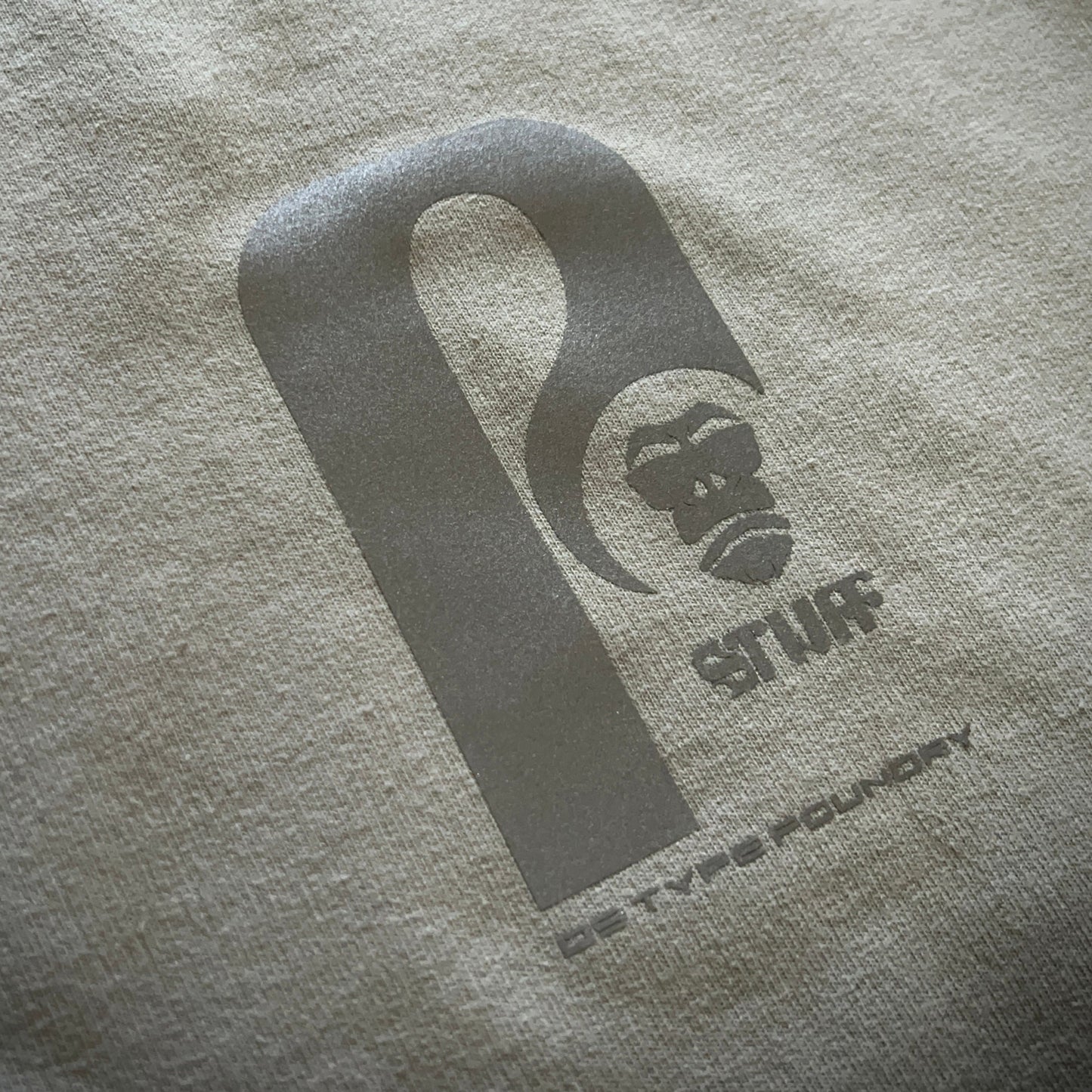 Reflective Stuff logo on grey. Typeface: Stuff