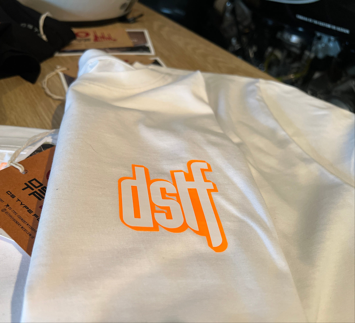 DSTF logo in Fluorescent Orange and white on quality cotton white tee