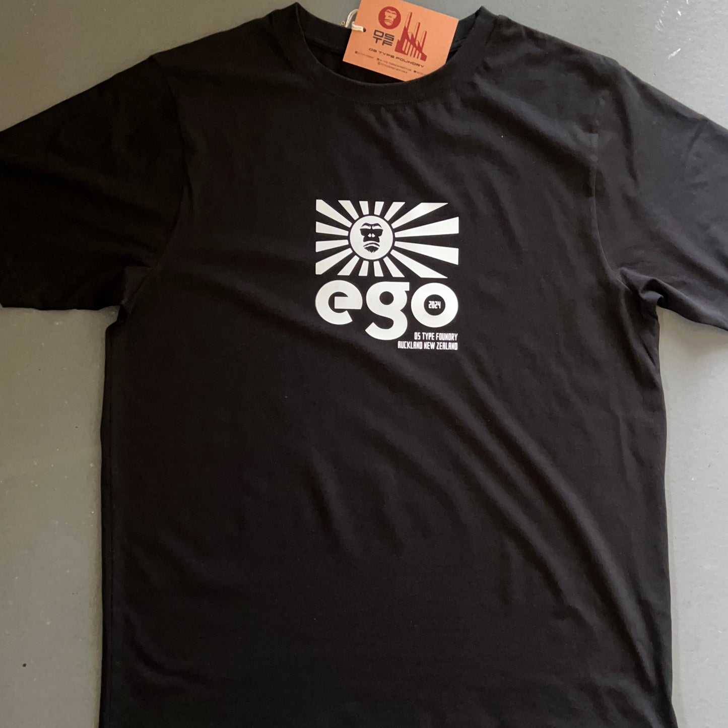 Ego in White on Black 100% cotton. Typeface: Ego