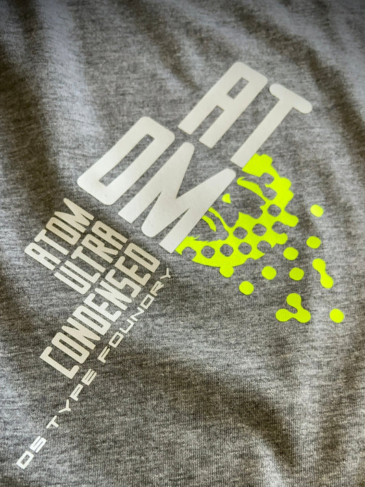 Atom in White and neon yellow on grey, 100% cotton Tee.
