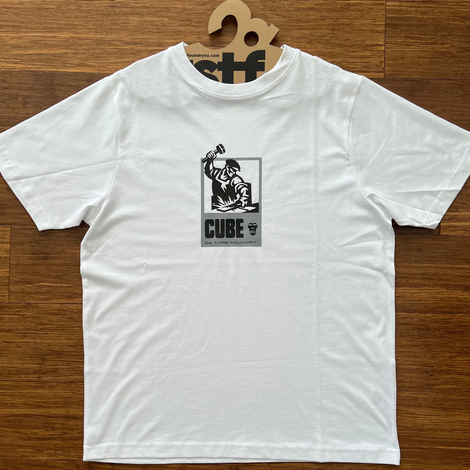 White t-shirt with Constructivist inspired graphic with Cube typeface. Shown in black and grey
