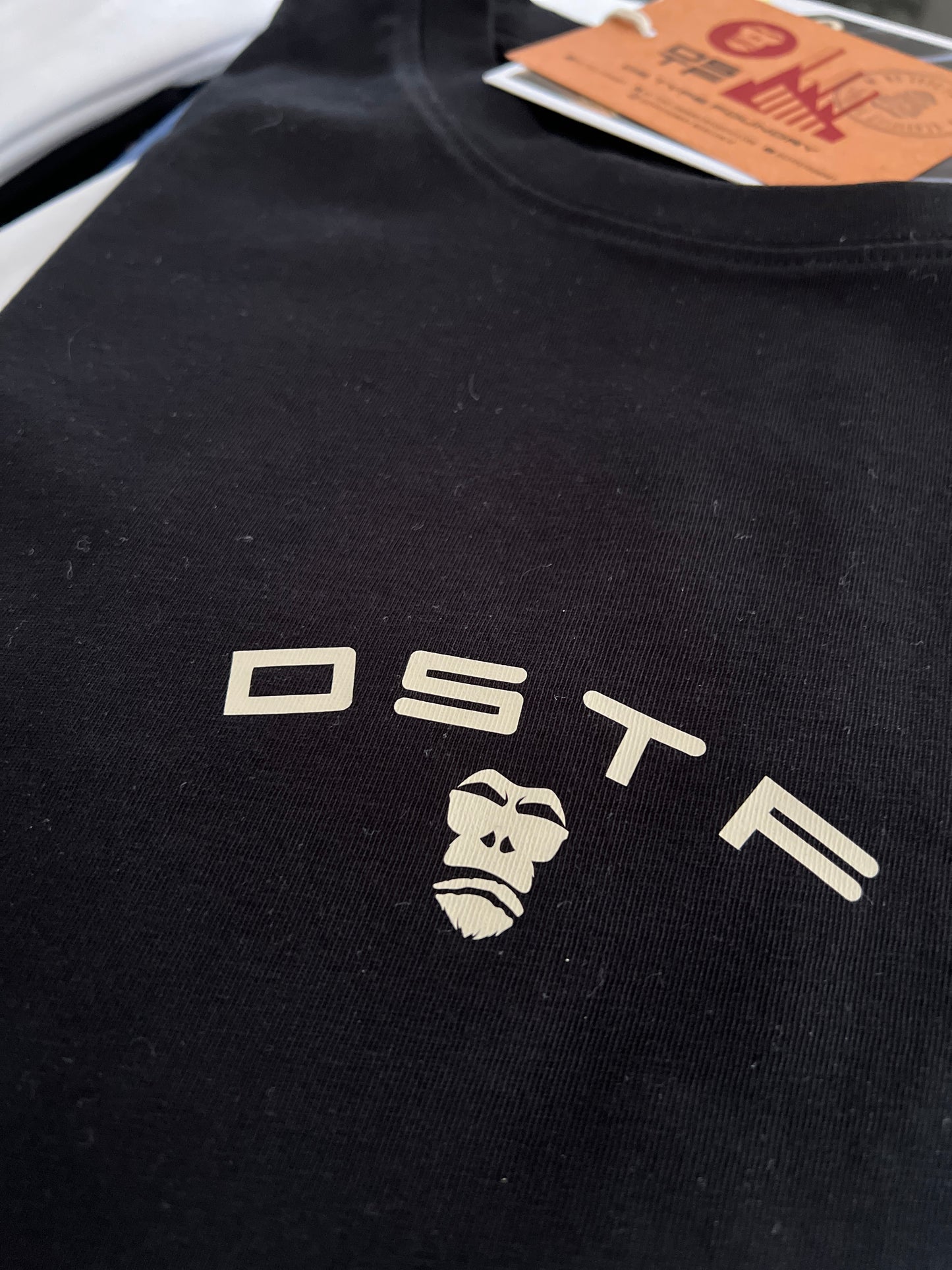 100347 DSTF logo in cream on black cotton tee