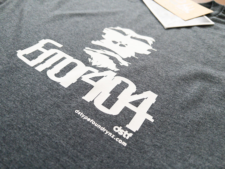 Gray t-shirt with white graphic design and text on a plain background