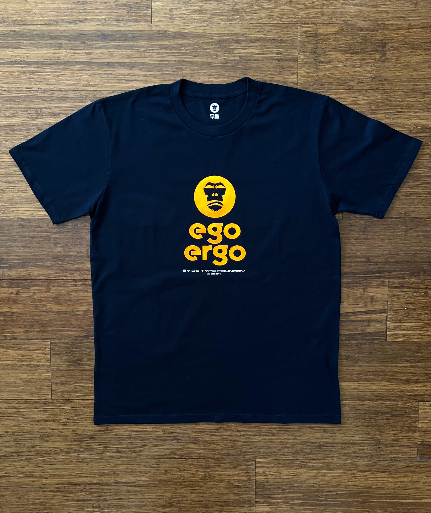 Ego Ergo in Neon Orange on dark navy blue tee, 100% cotton 220gsm. Typeface: Ego