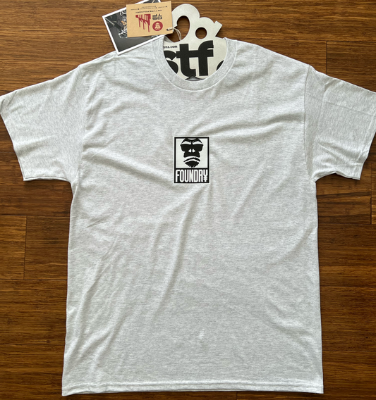 Grey t-shirt with a logo on a wooden surface