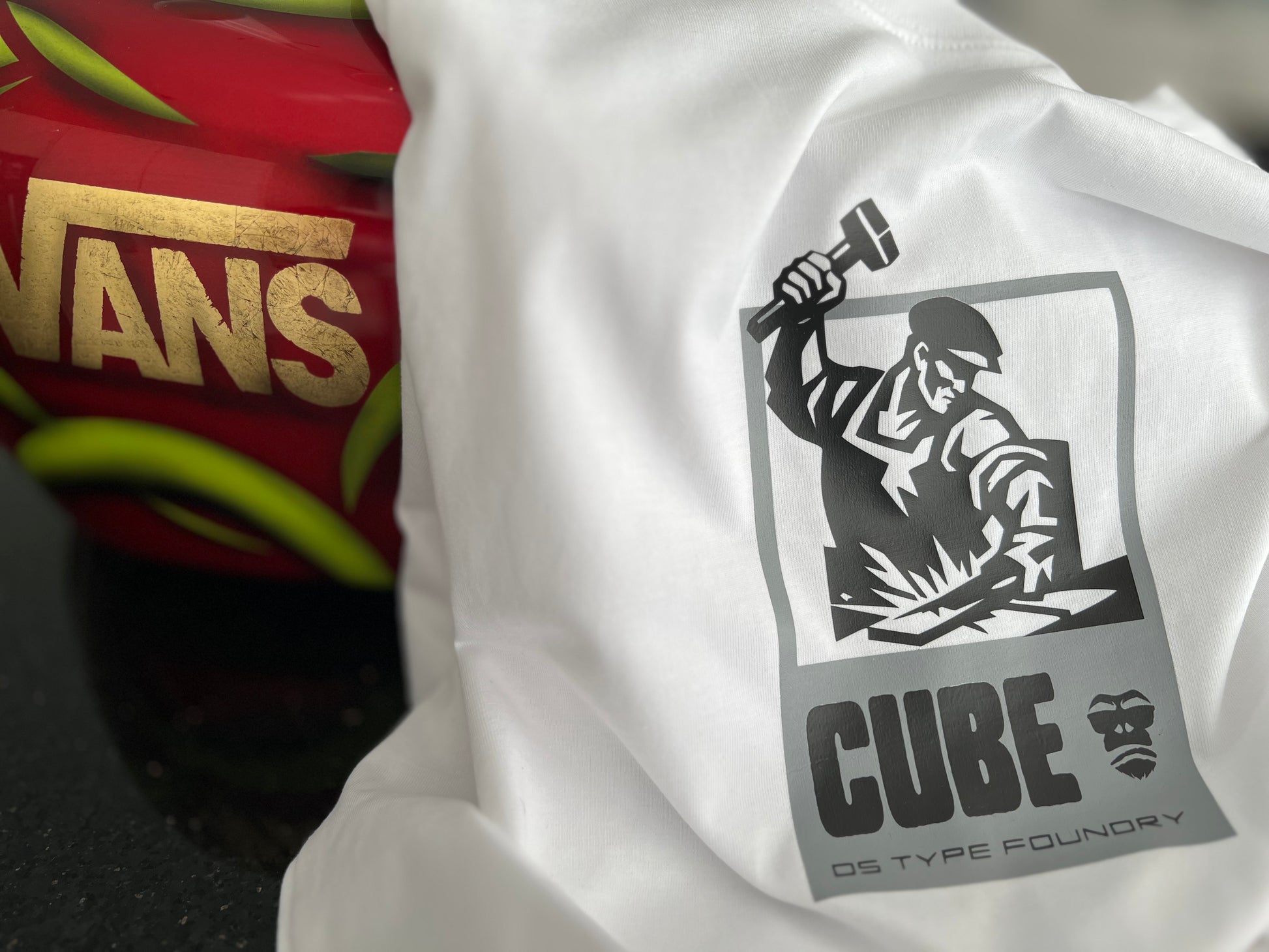 White tshirt with a black and gray 'Constructivist inspired graphic CUBE' logo