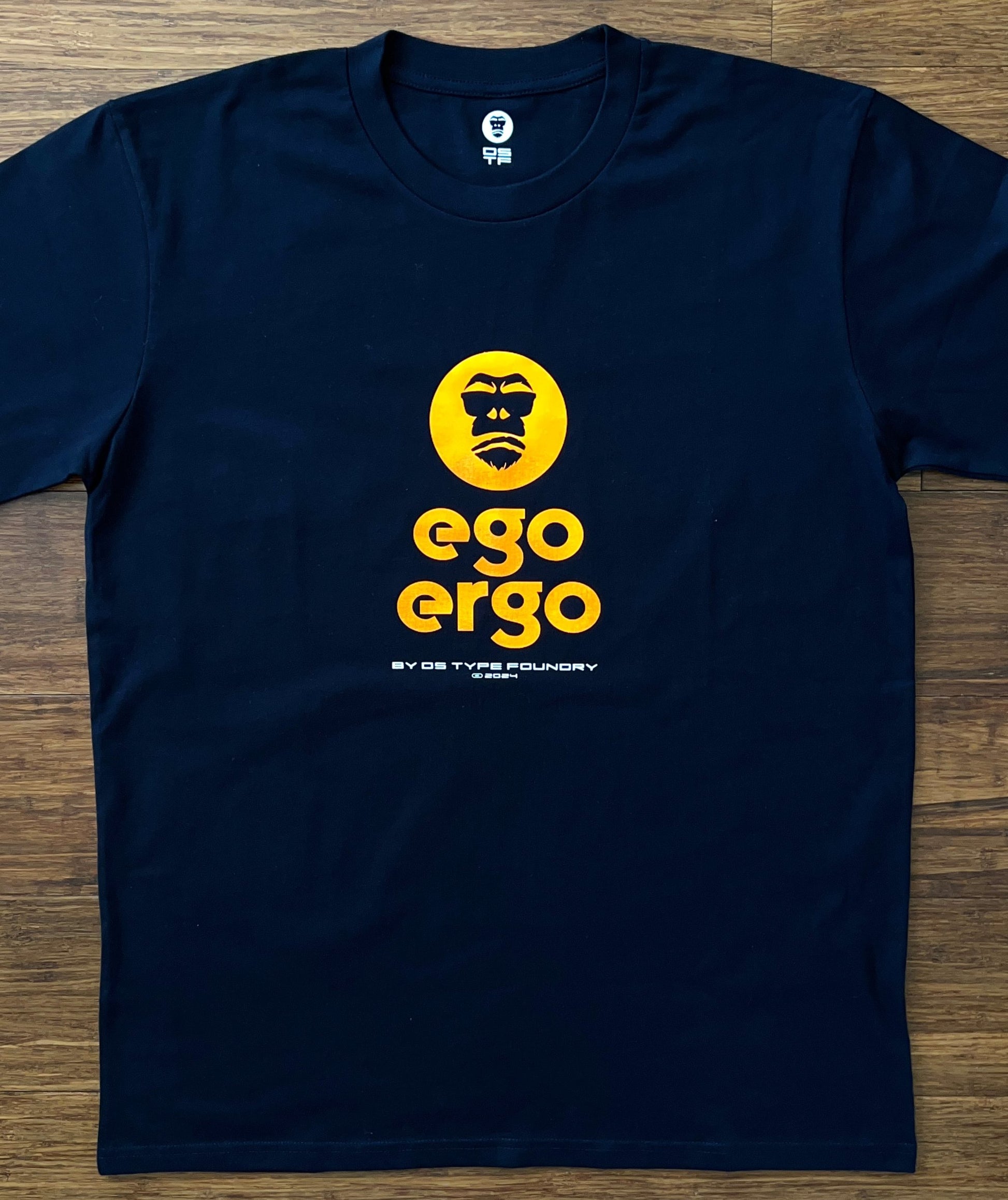 Ego Ergo in Neon Orange on dark navy blue tee, 100% cotton 220gsm. Typeface: Ego