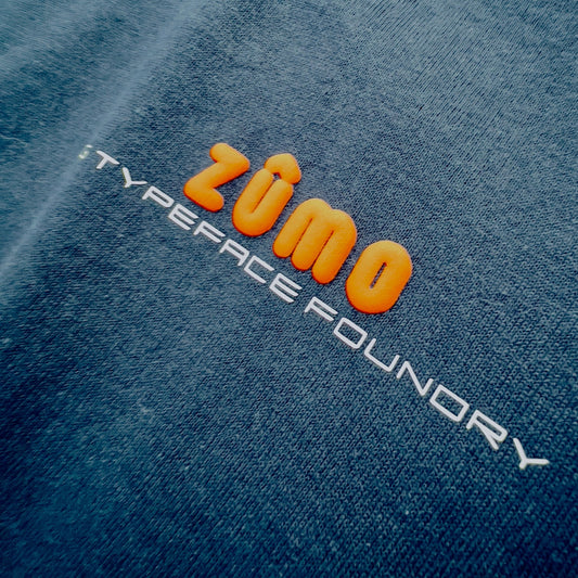 Zumo Puff Orange on Black tee. 100% cotton. Typeface: Zumo