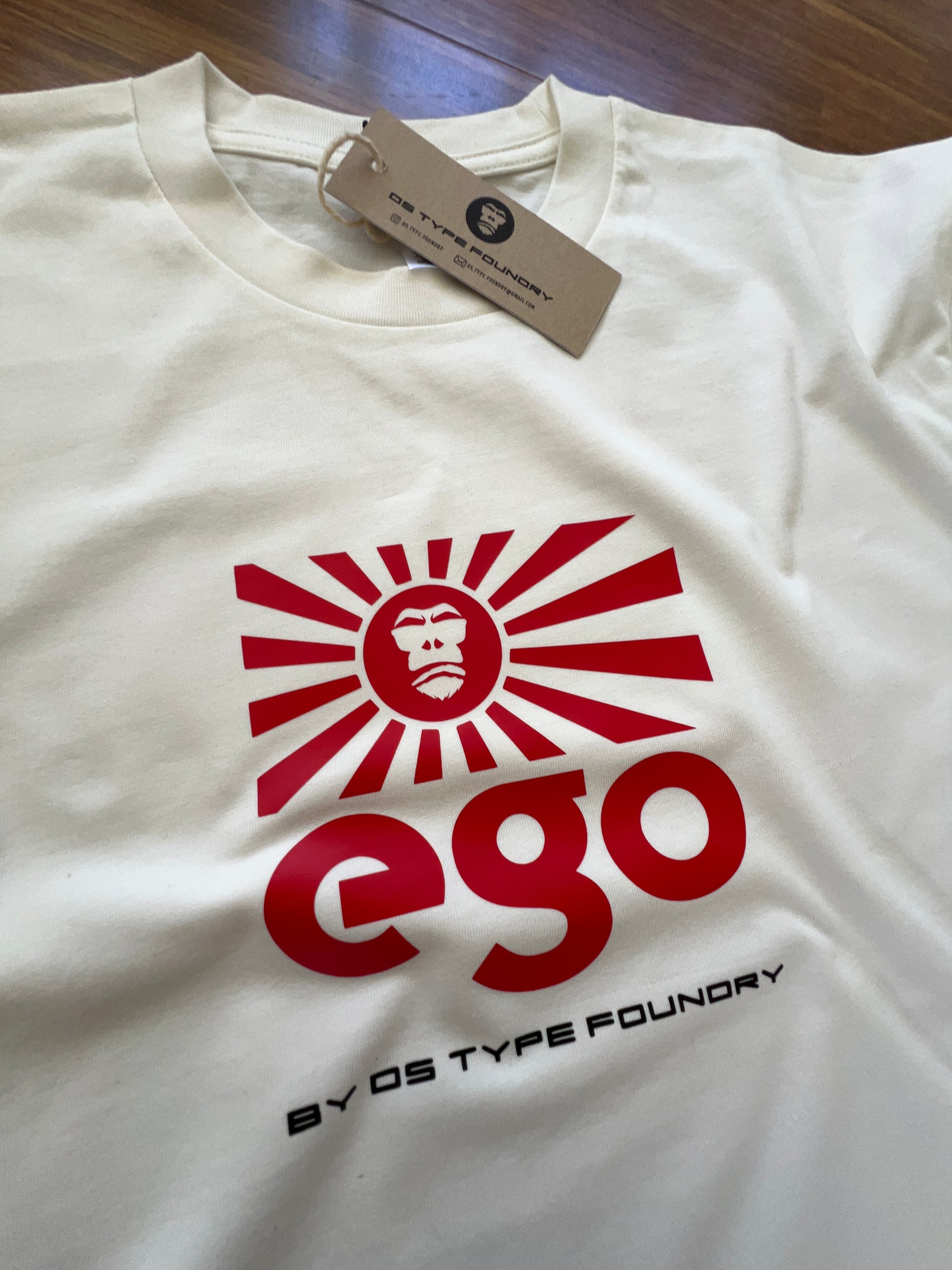 Ego in red on Natural White (cream) tee, 100% cotton 220gsm. Typeface: Ego