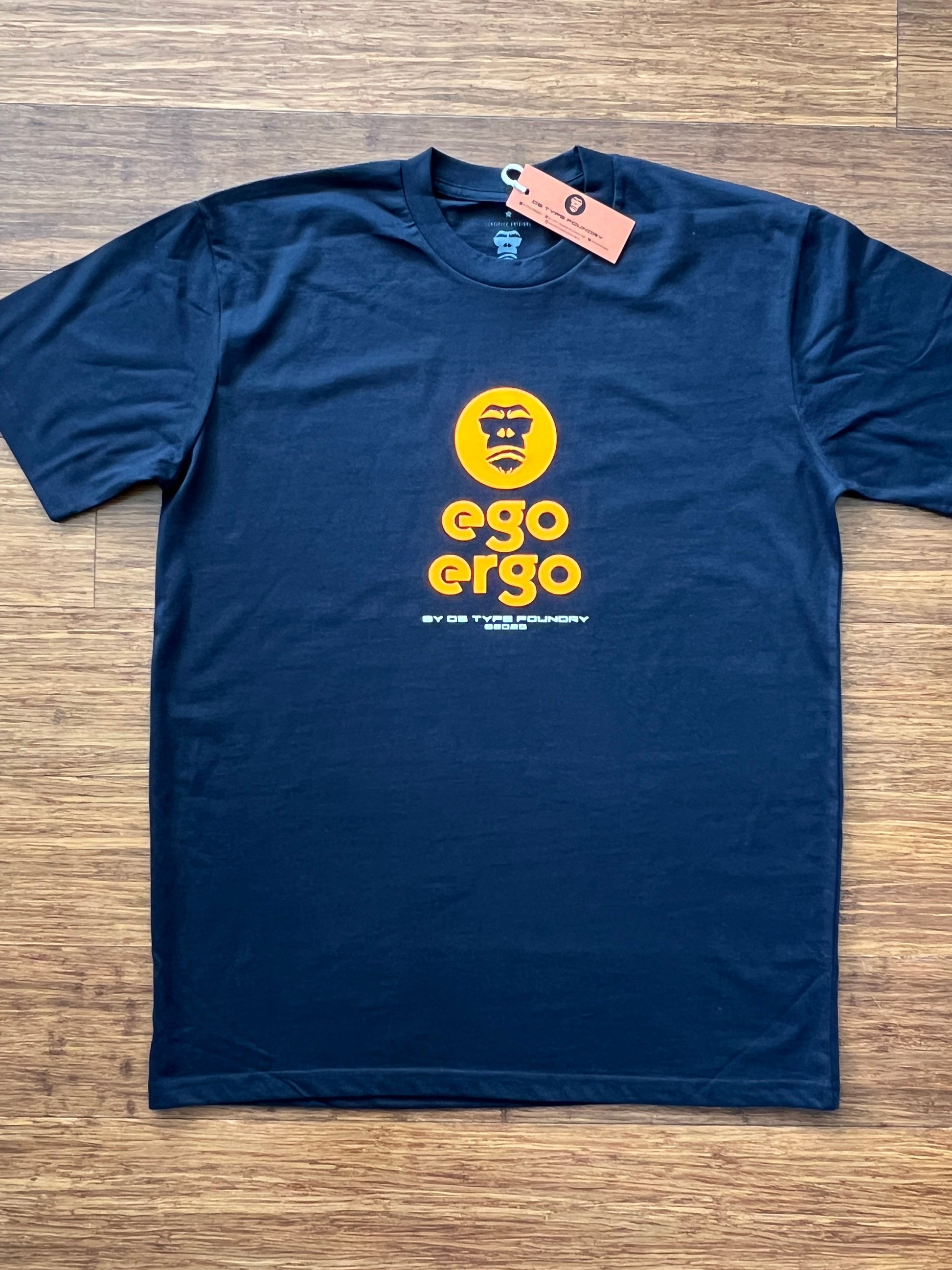 Ego Ergo in Neon Orange on dark navy blue tee, 100% cotton. Typeface: Ego