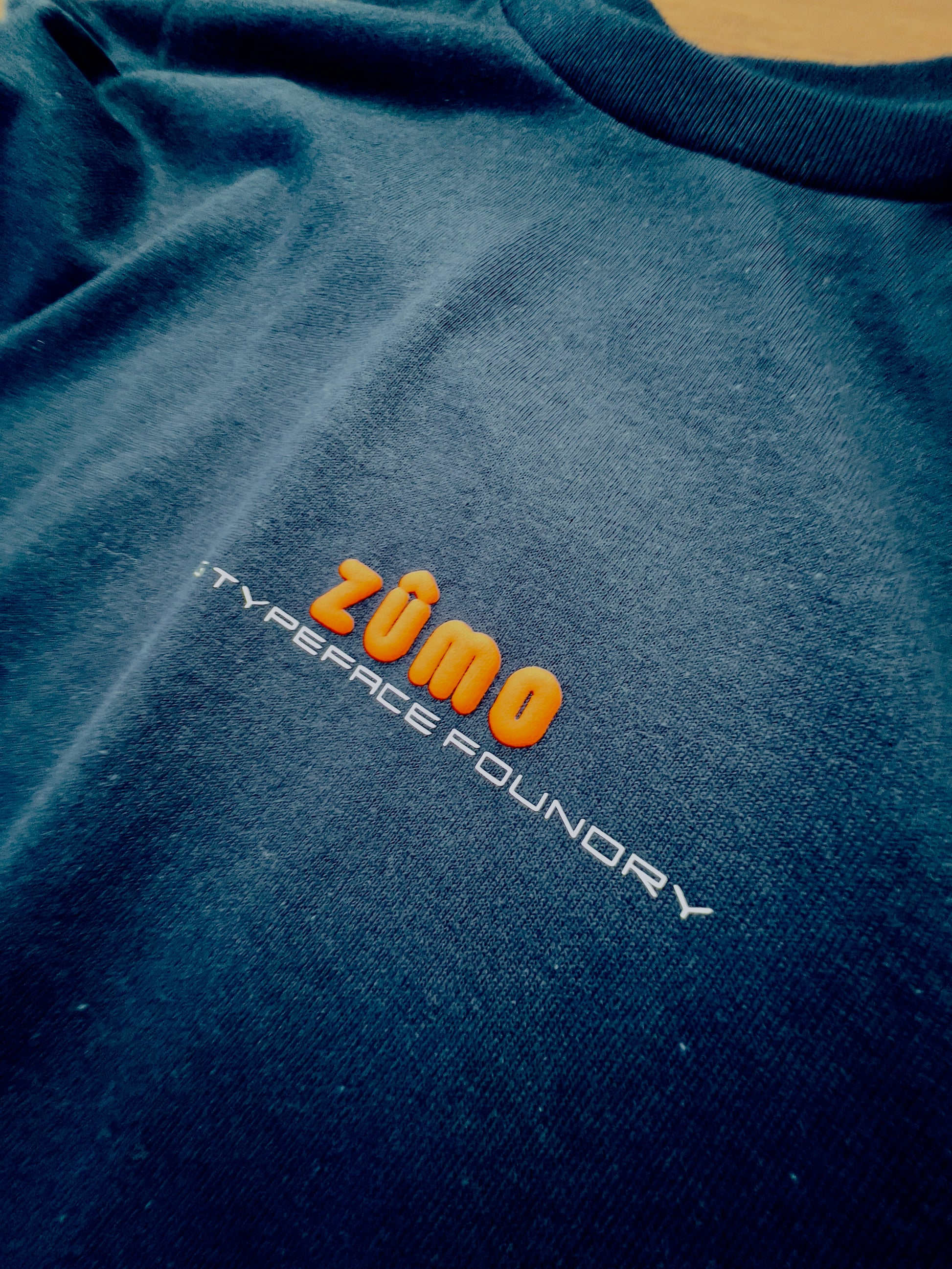 Zumo Puff Orange on Black tee. Heavyweight 100% cotton 220gsm. Typeface: Zumo