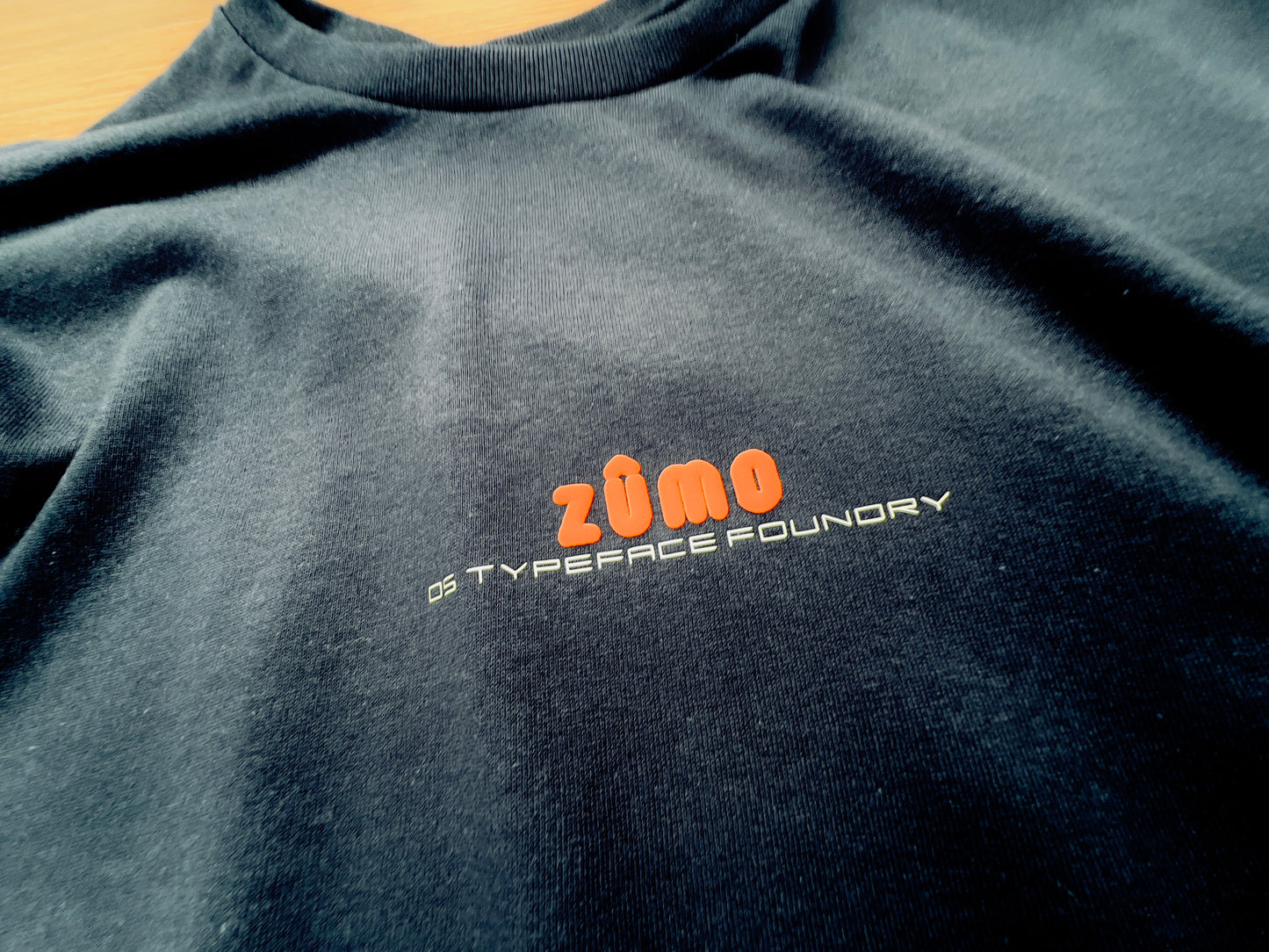 Zumo Puff Orange on Black tee.  100% cotton. Typeface: Zumo